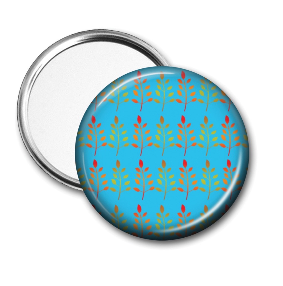 Pocket mirror with tinted foliage on a bright blue background