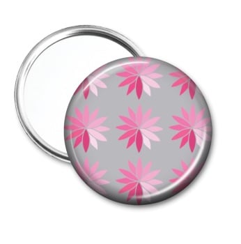 Pocket mirror with pink stylised flowers on a grey background