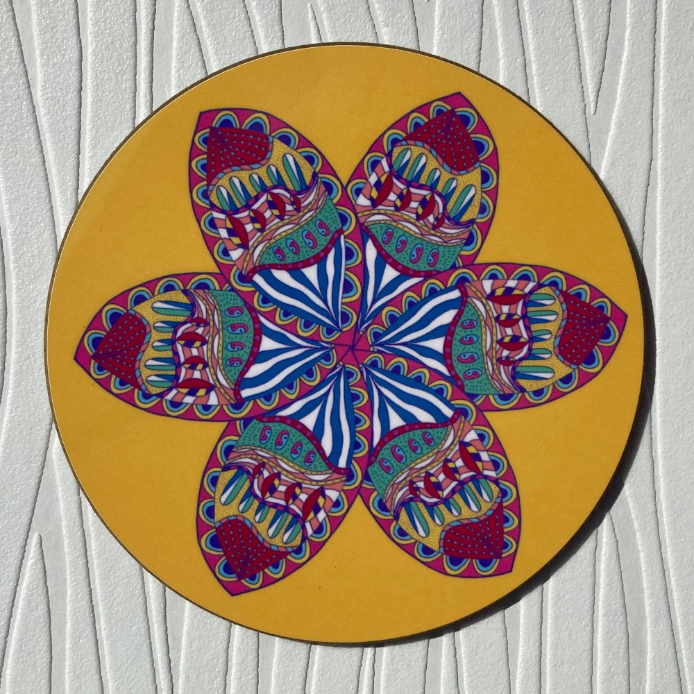 Circular yellow coaster with a stylised flower