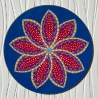 Circular blue coaster with stylised flower decoration