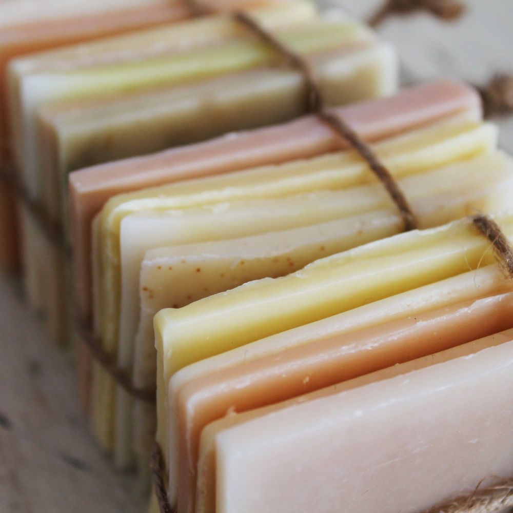 Thin slices of different coloured soaps tied together in bundles with brown