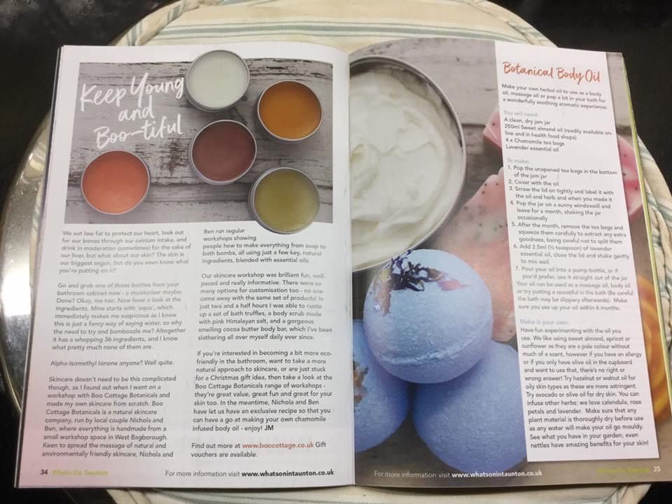 Magazine open with colourful lip balm pots and pale blue bath bombs