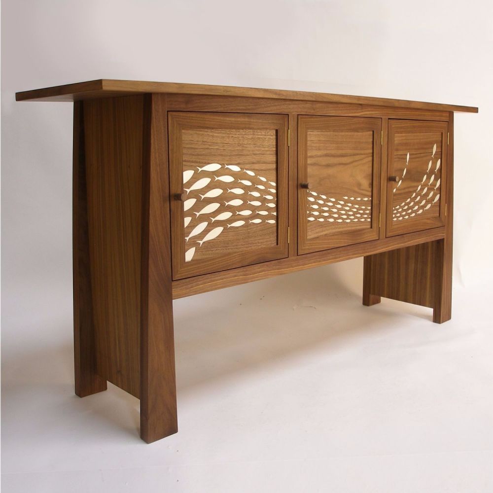 Flow sideboard in walnut with gilded fish.