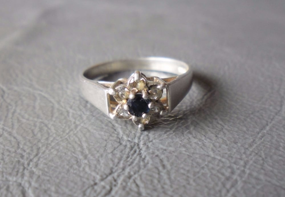 Vintage silver cluster ring with a deep blue sapphire