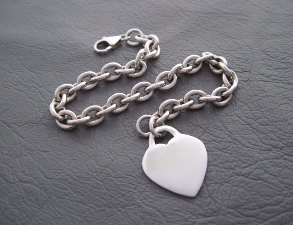 Sterling silver bracelet with a single solid heart charm