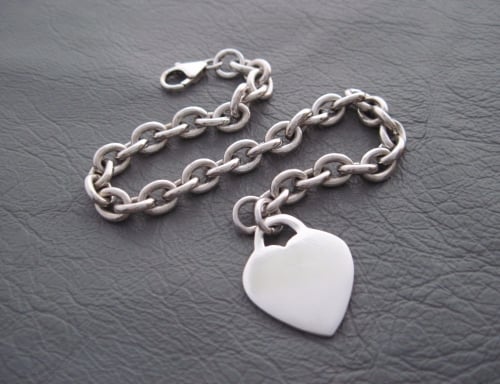 Sterling silver bracelet with a single solid heart charm