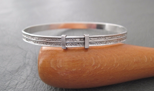 Vintage sterling silver Christening bangle; feathered leaf scroll