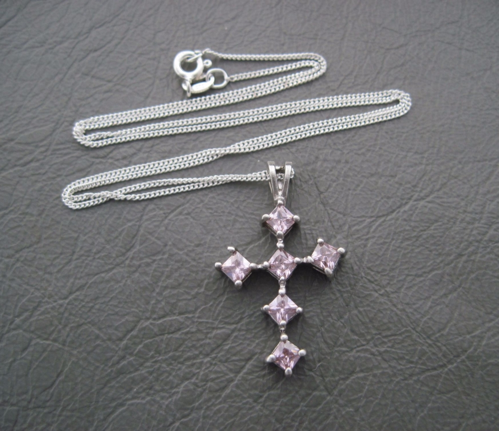 Sterling silver necklace with a pink stoned cross pendant