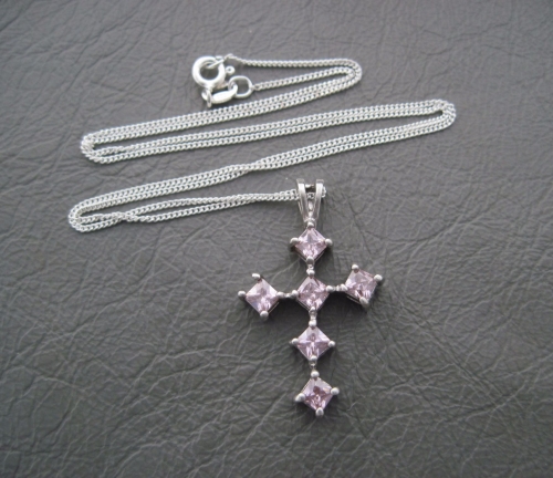 Sterling silver necklace with a pink stoned cross pendant