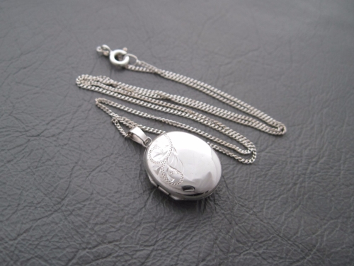 Vintage sterling silver necklace with an engraved oval locket