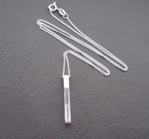 Sterling silver necklace with a long slim clear stone pendant