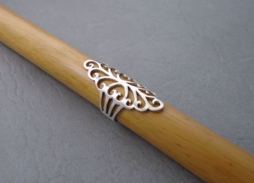 Long sterling silver ring with fancy cut-out detail
