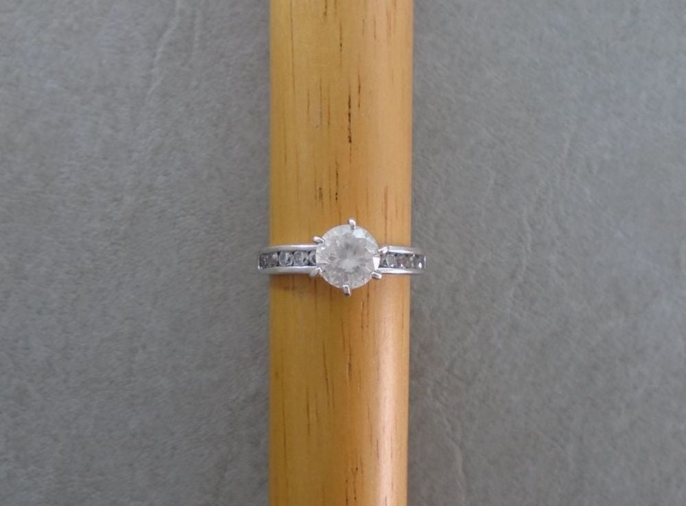Proud set sterling silver solitaire ring with accented shoulders