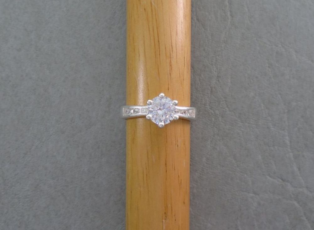 Sterling silver solitaire ring with stone accented shoulders