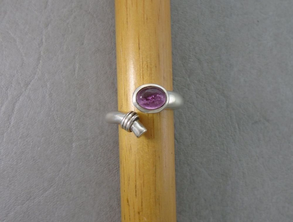 Sterling silver bypass ring with a pink oval stone
