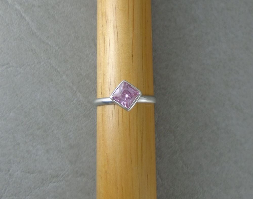 Off-set sterling silver & pink square solitaire ring