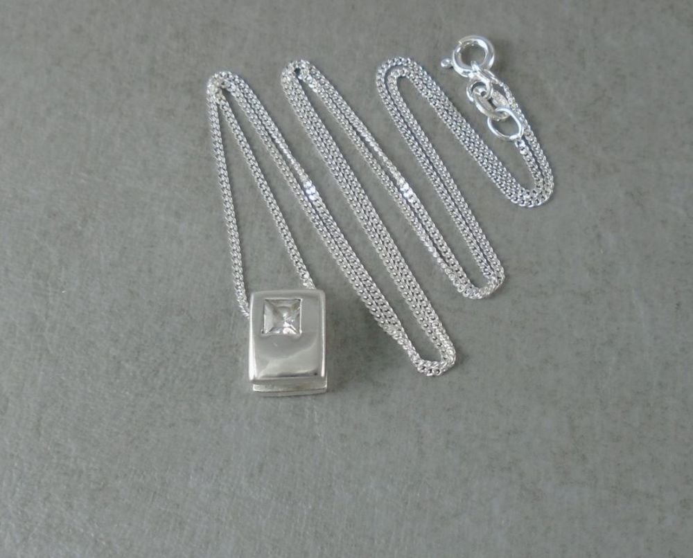 Sterling silver necklace with a small stone set rectangular pendant
