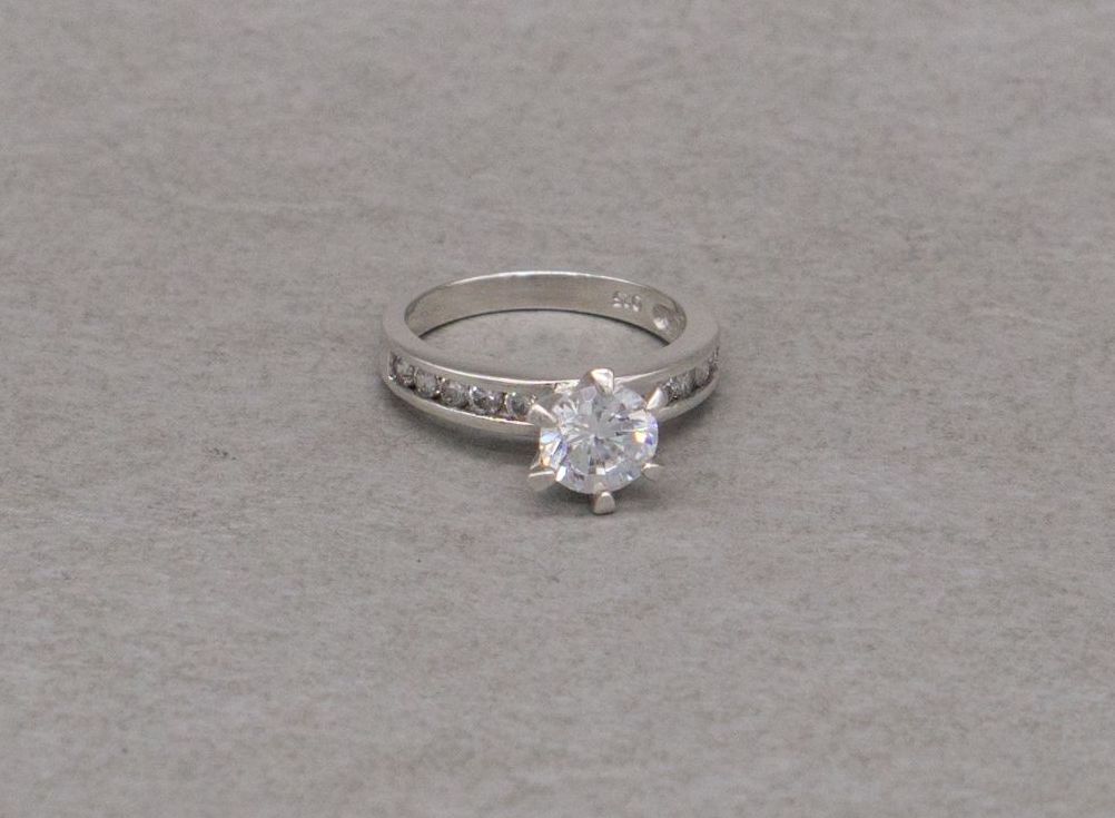 Sterling silver proud set solitaire ring with accented shoulders