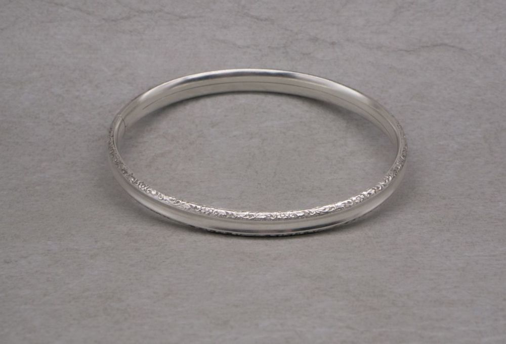 Vintage sterling silver floral scroll edged bangle