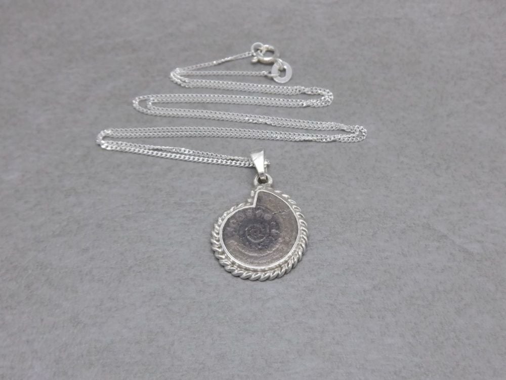 Sterling silver necklace with a small fossil pendant