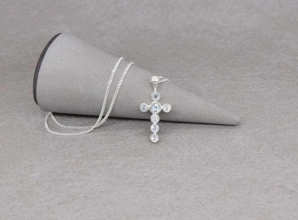 Small sterling silver & pale blue topaz cross necklace