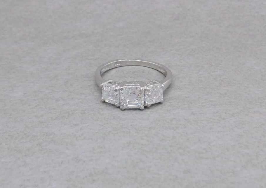 Graduated sterling silver square stone trilogy ring