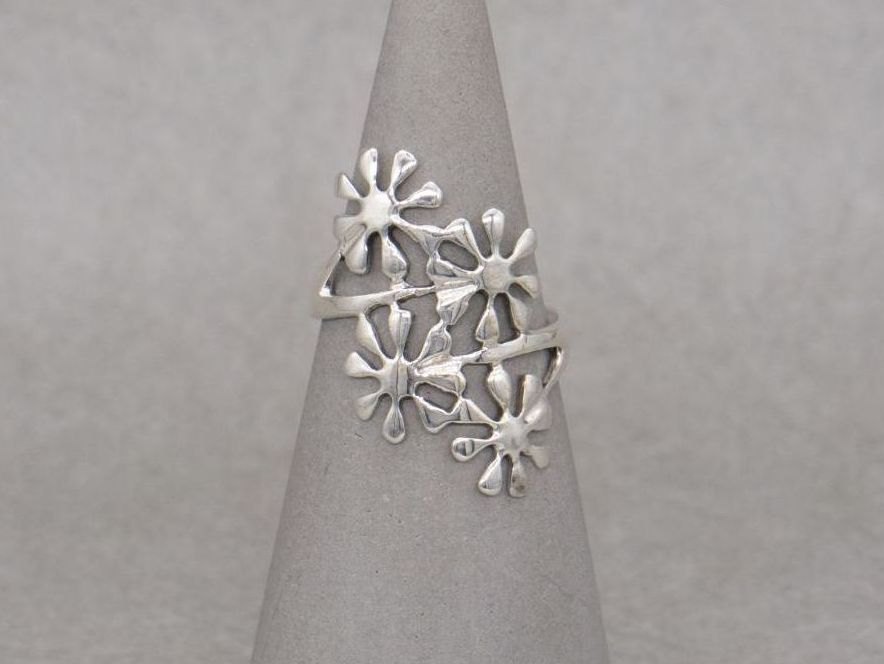 Long sterling silver flower bypass ring