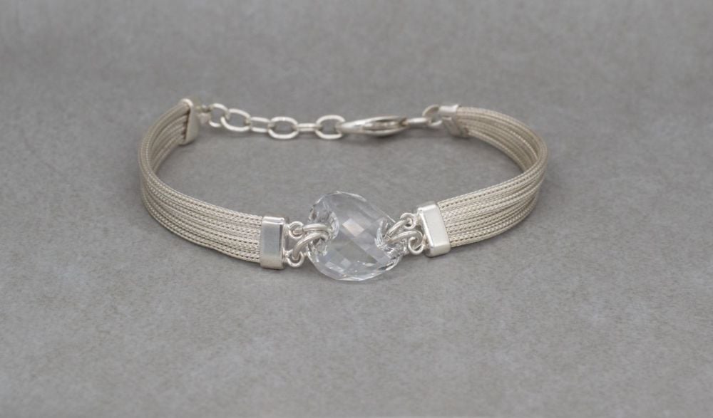 Sterling silver multi-chain bracelet with a faceted clear crystal