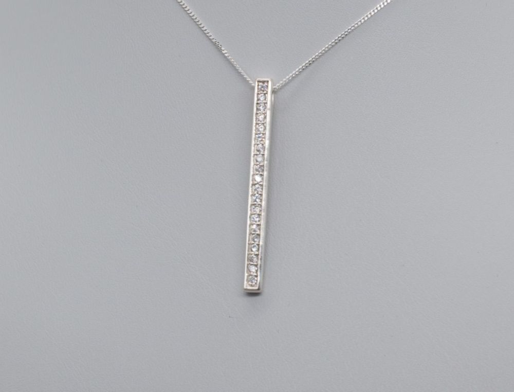 Sterling silver necklace with a long slim clear stone pendant
