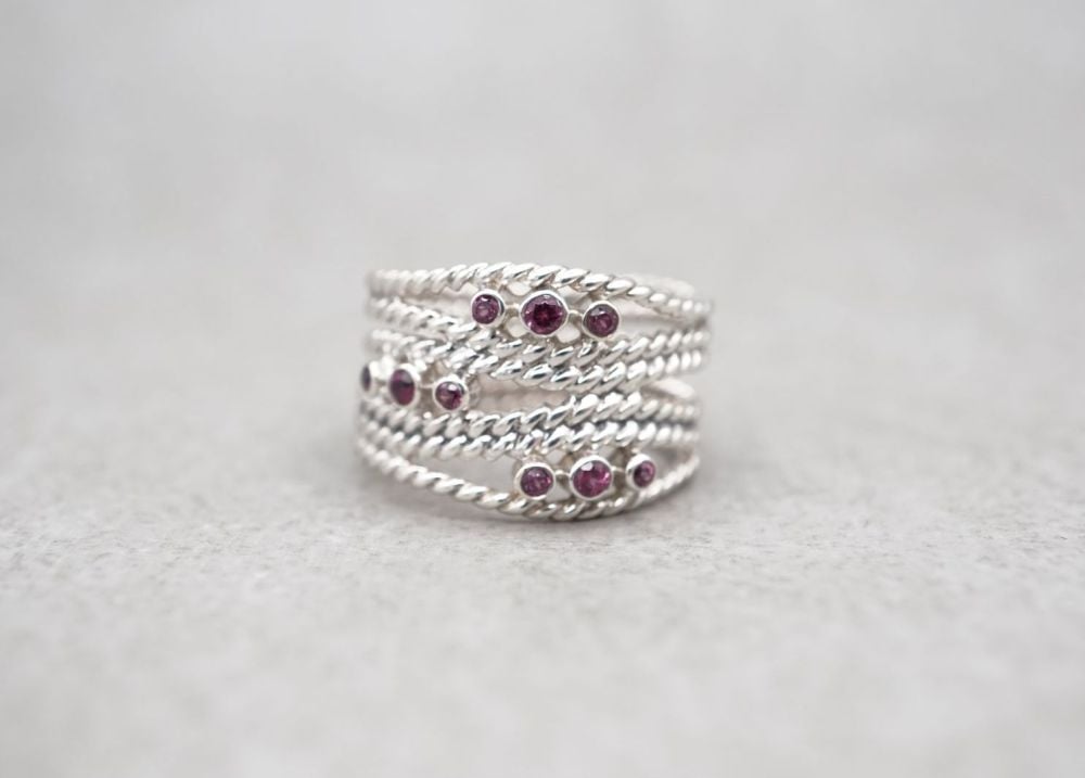 Wide sterling silver multi-band effect ring with deep pink stones