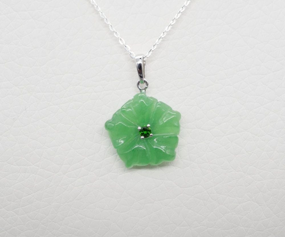 Sterling silver necklace with a carved green jade floral / flower head pend