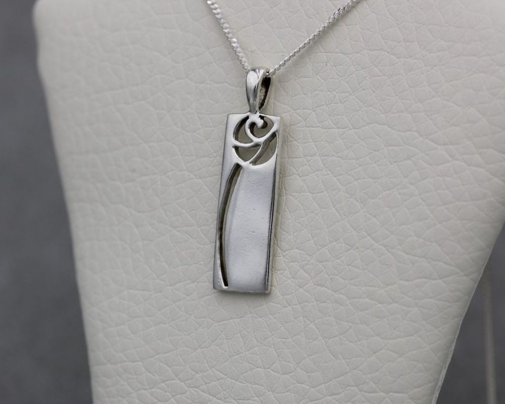 Sterling silver necklace with a cut-out rose pendant