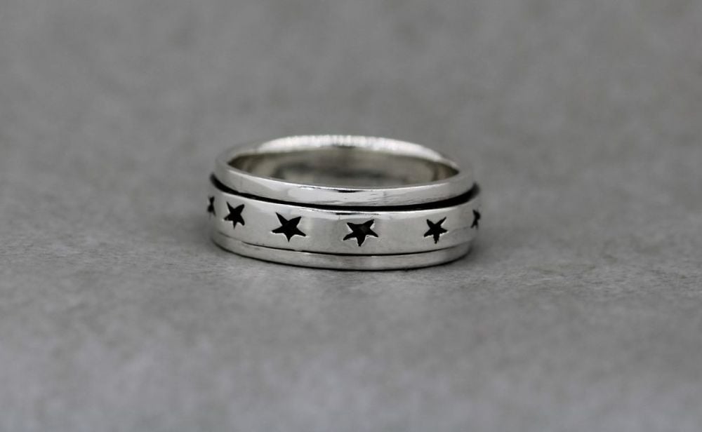 Sterling silver spinner ring with oxidised stars