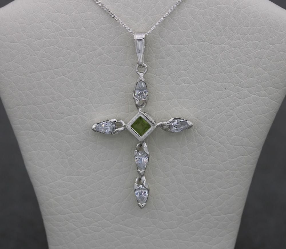 Sterling silver necklace with a green & clear stone cross