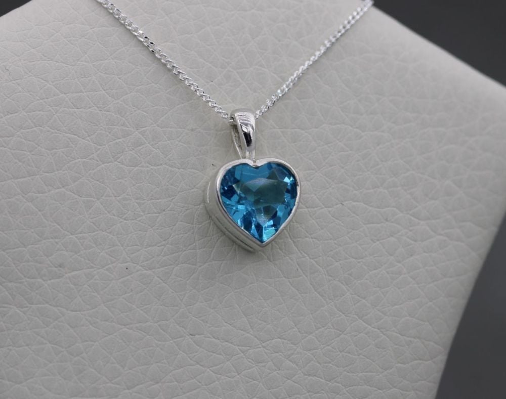 Sterling silver necklace with a blue faceted heart