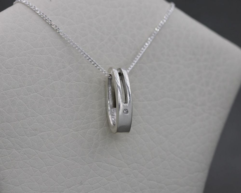 Sterling silver necklace set with a tiny clear stone