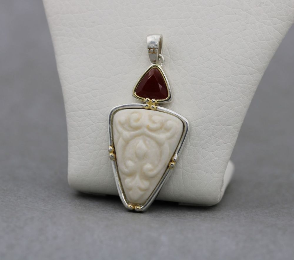 Sterling silver pendant with a carved cream stone & faceted carnelian