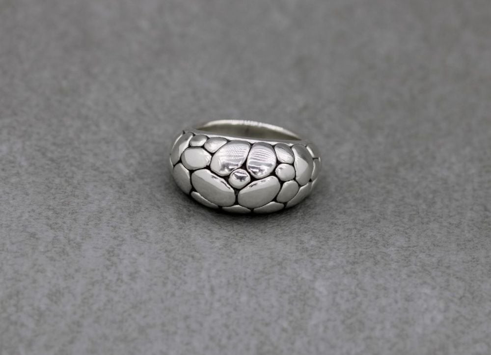 Domed sterling silver ring with an oxidised pebble design