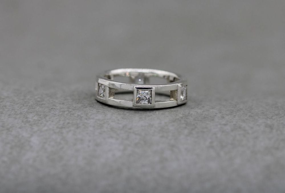 Sterling silver ring with evenly spaced clear square stones