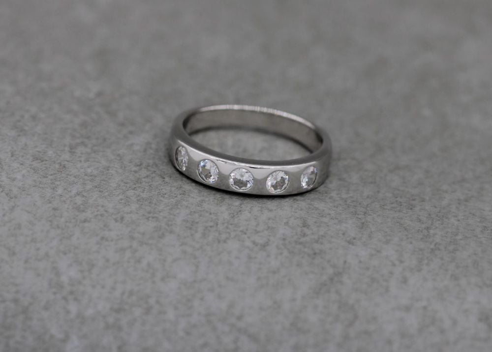 Sterling silver ring with five flush set clear stones