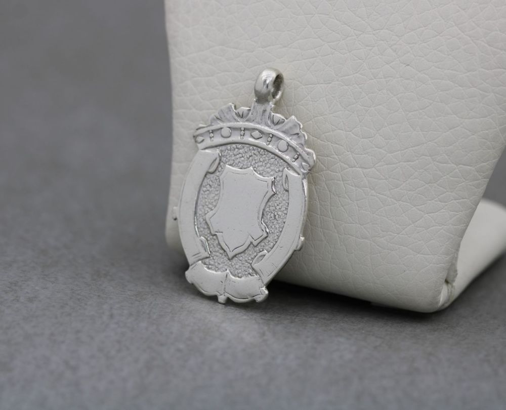Vintage sterling silver fob with shield and scroll design