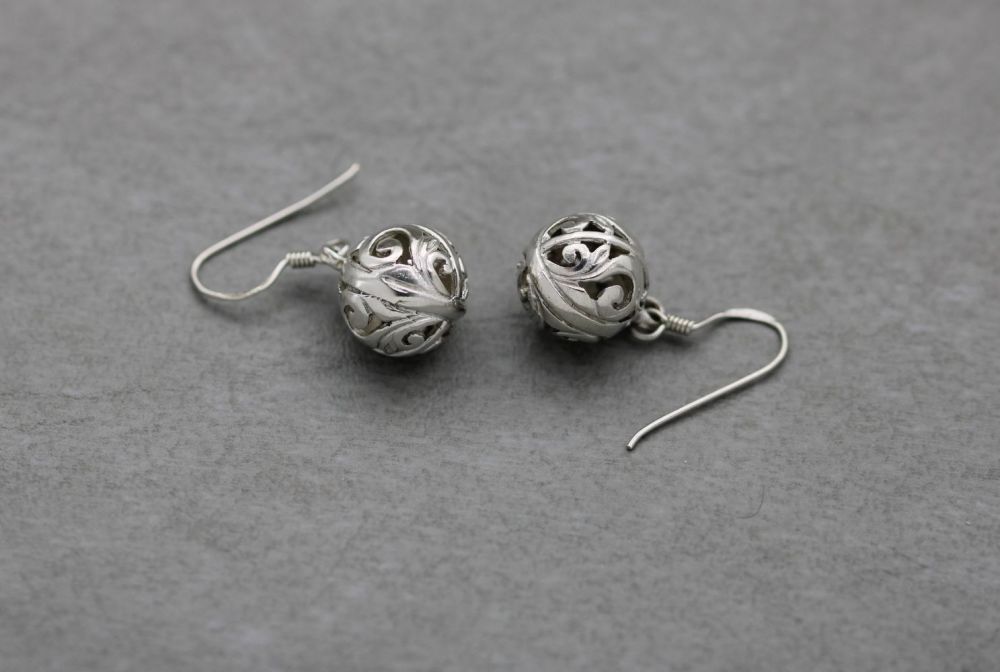 Decorative sterling silver cut-out sphere earrings