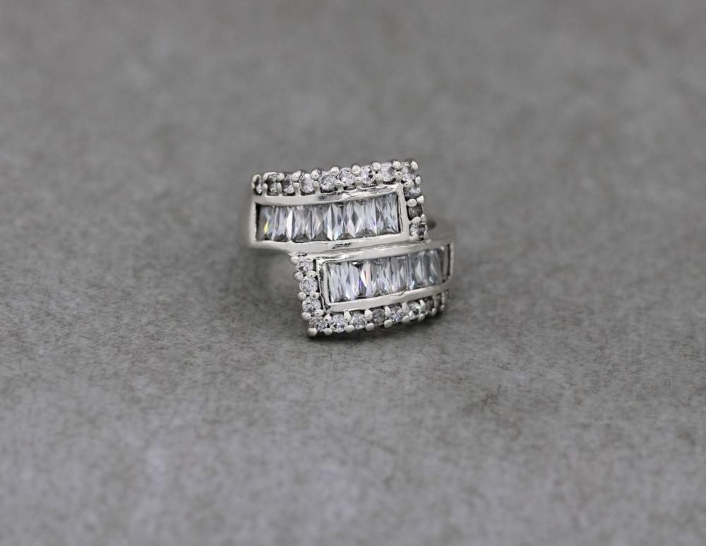Wide sterling silver & multi-cut clear stone bypass ring
