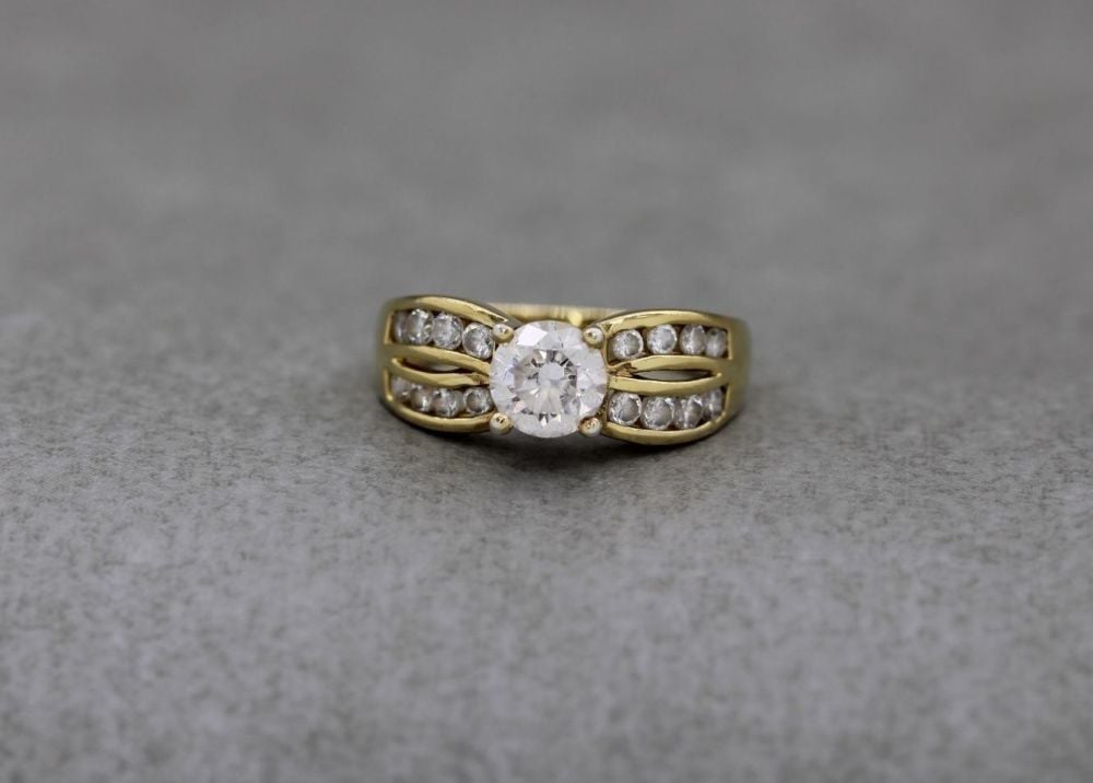 Gilt sterling silver & clear stone ring with fancy shoulders