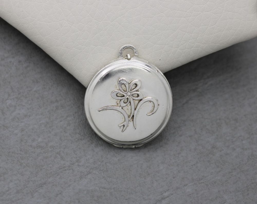 Vintage sterling silver locket with a flower