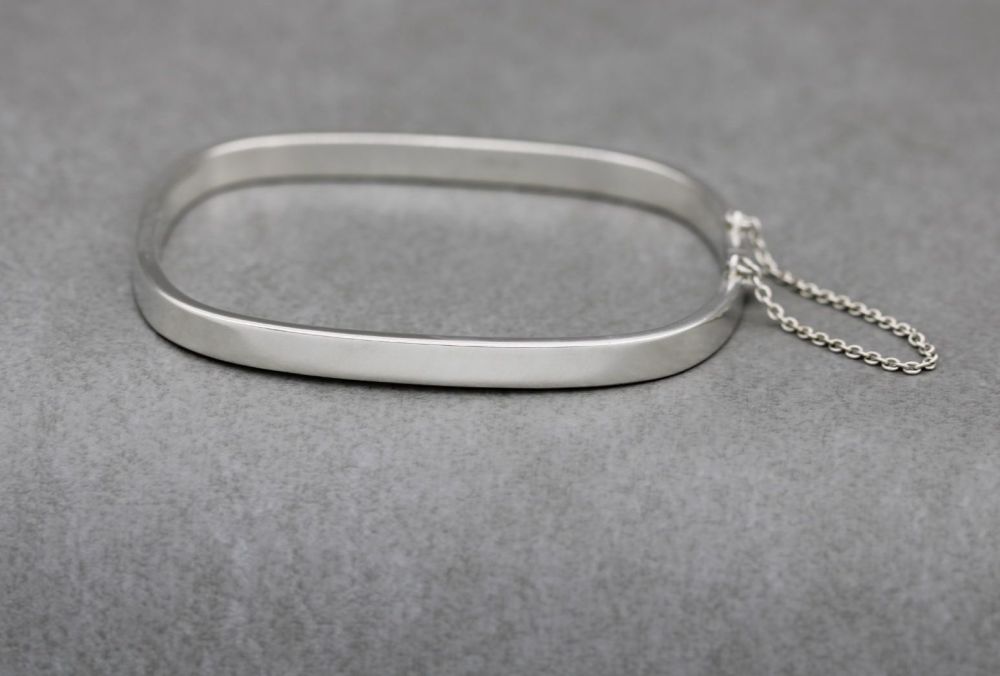 Rectangular sterling silver bangle with safety chain