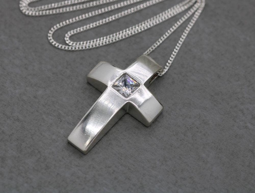 Sterling silver necklace with a shaped clear stone set cross