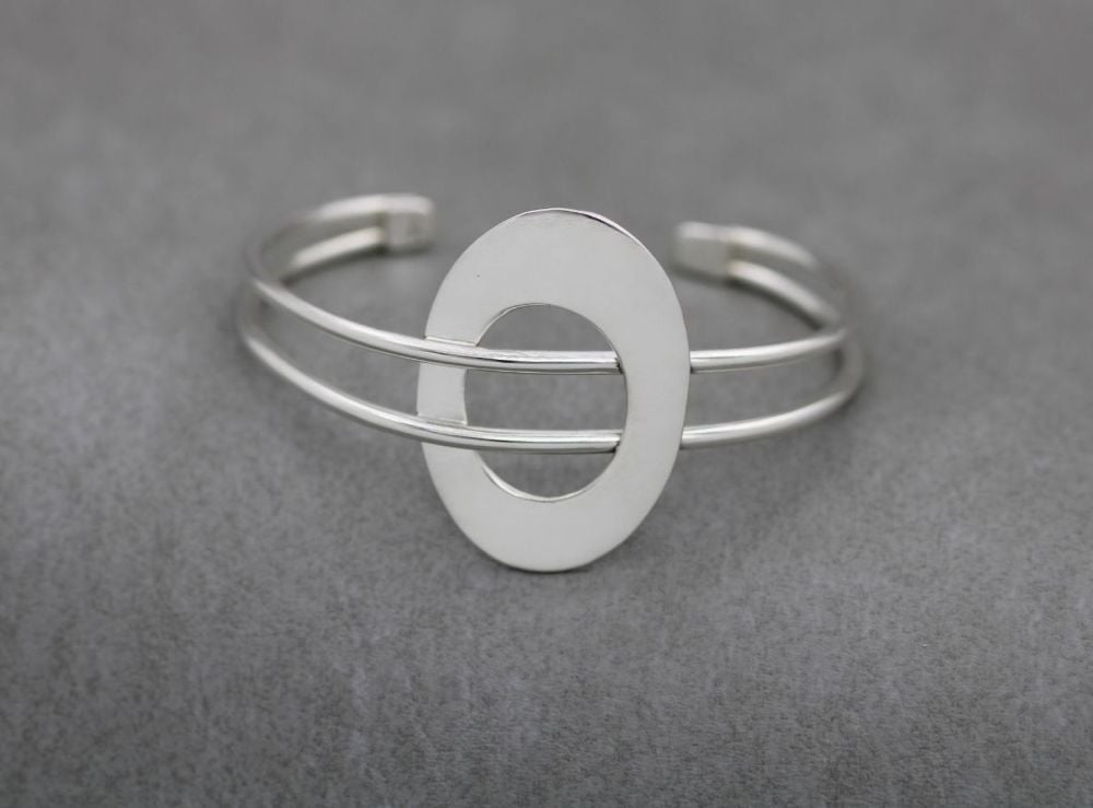 Wide sterling silver cuff with an oval feature