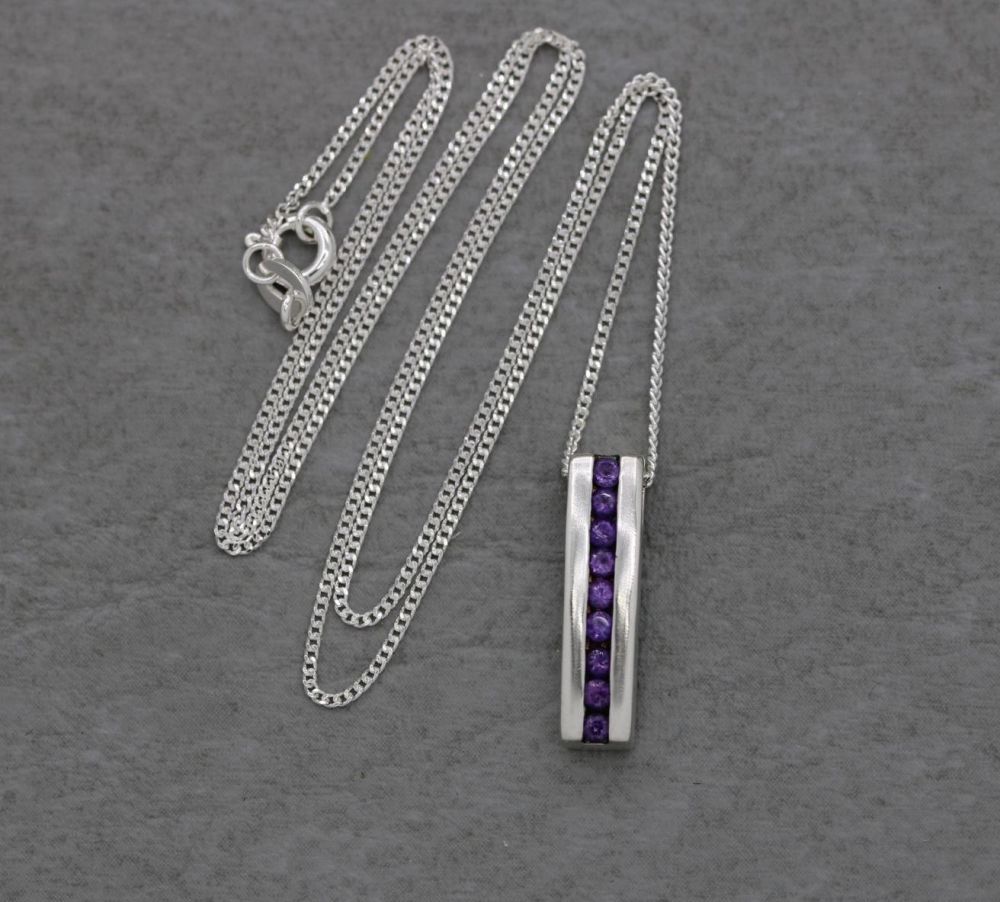 Small sterling silver necklace with purple stones