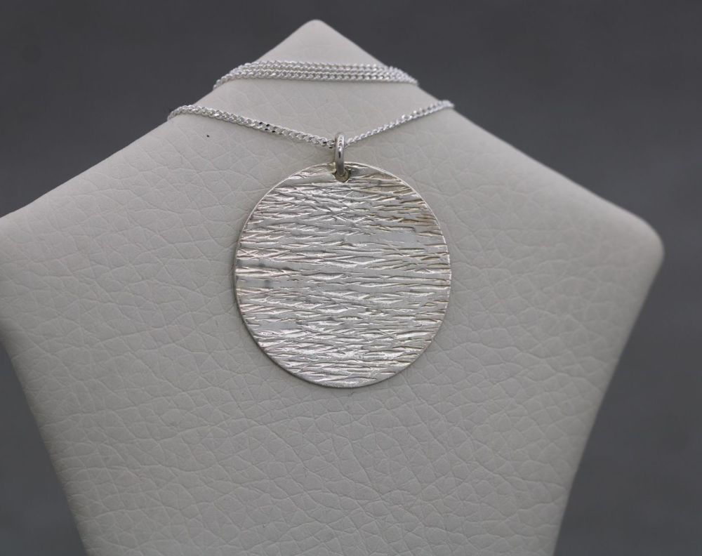 Handmade textured sterling silver disc necklace